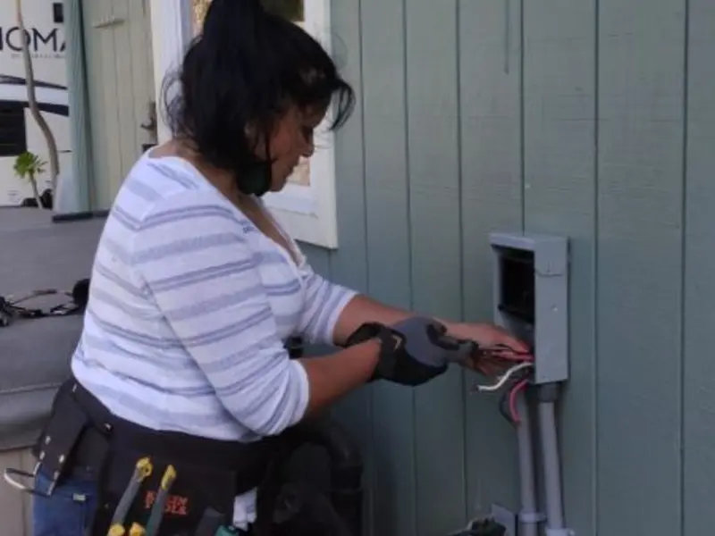 Licensed electrician wiring an exterior subpanel in Slaton